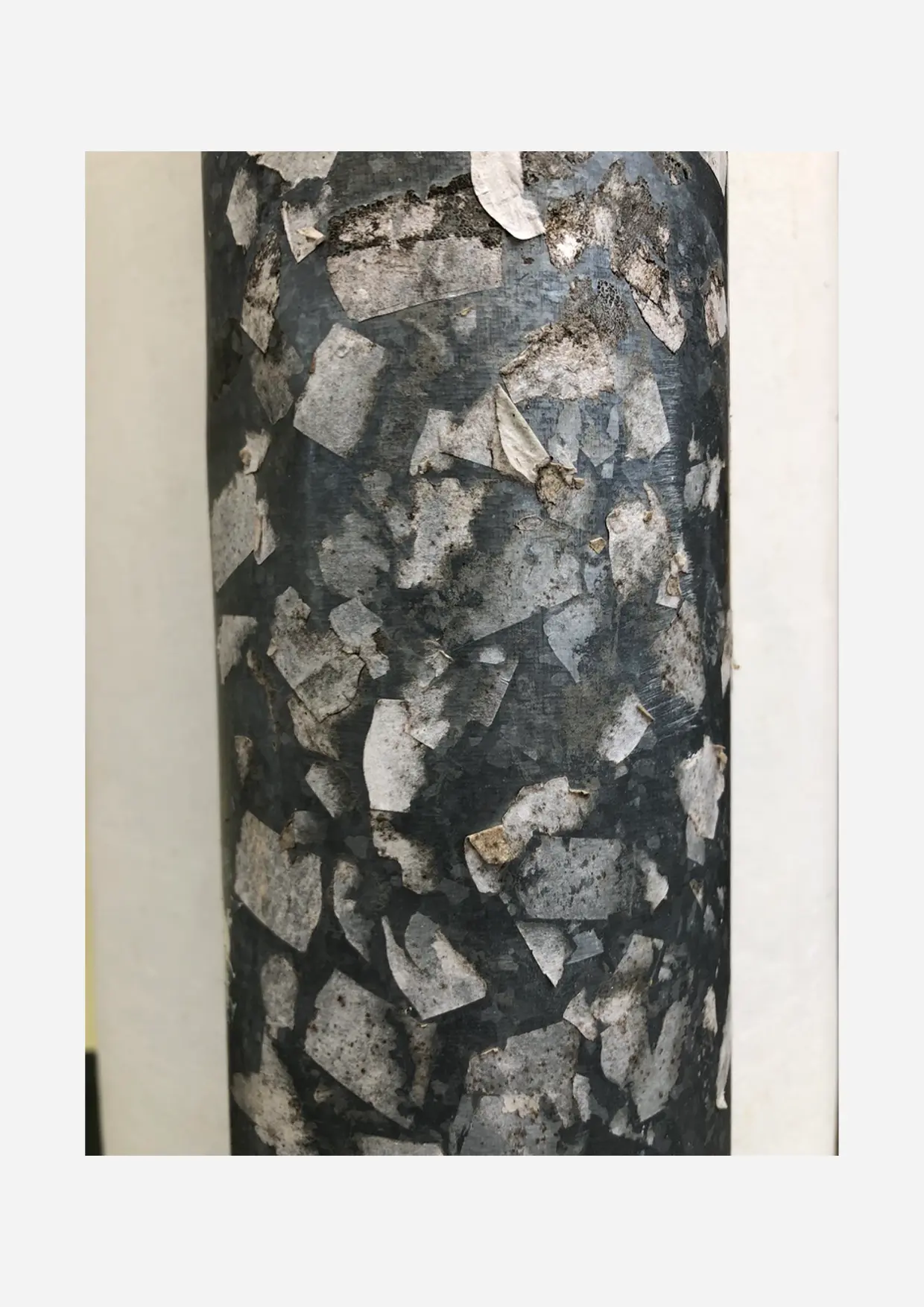 Weathered adhesive-covered column.