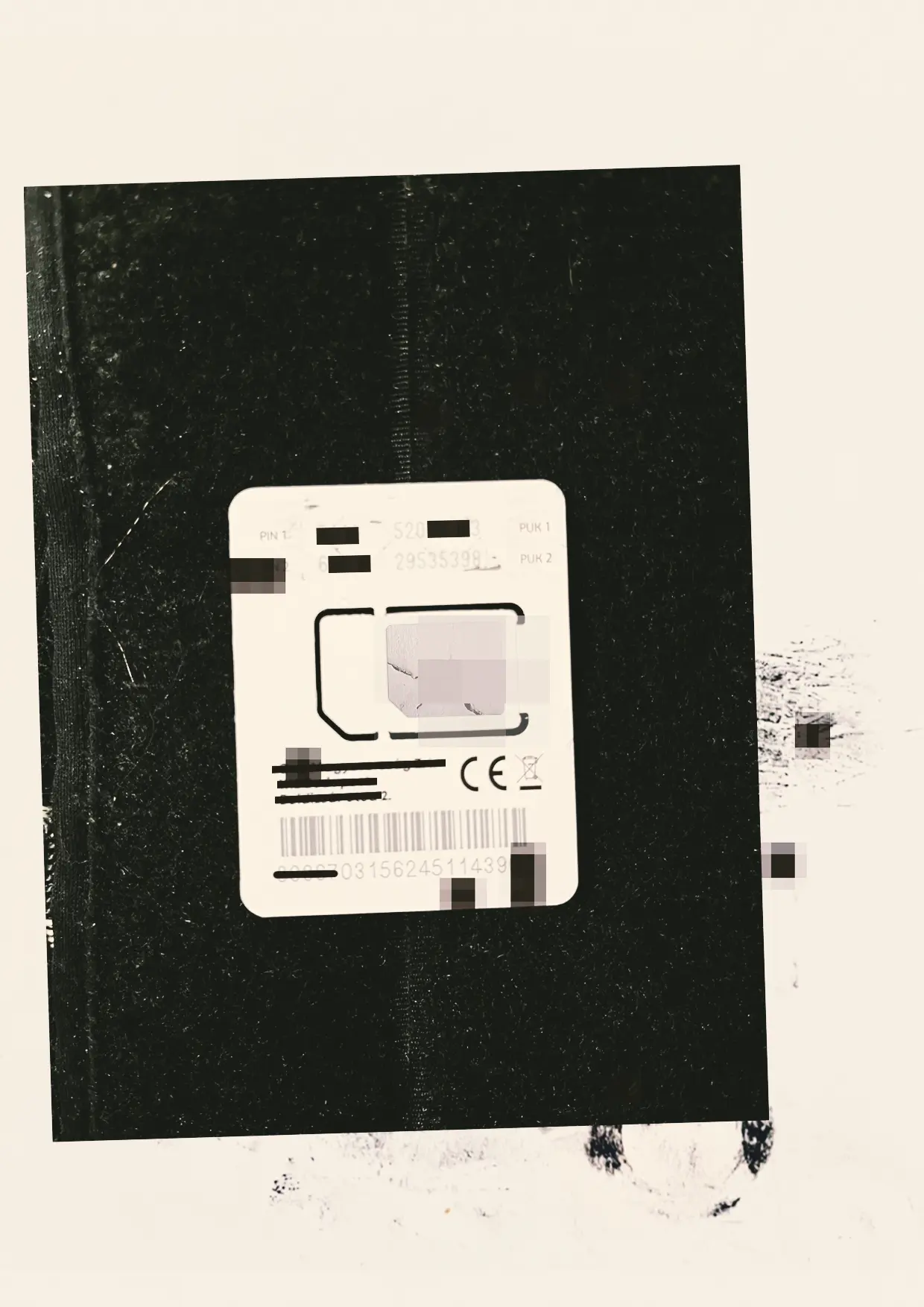 SIM card against a dark worn surface.